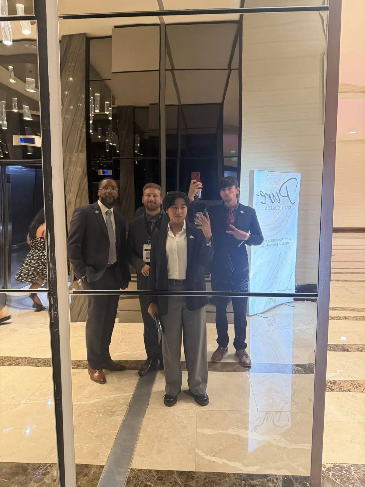 Four team members dressed up in Houston for the 2026 National Conference